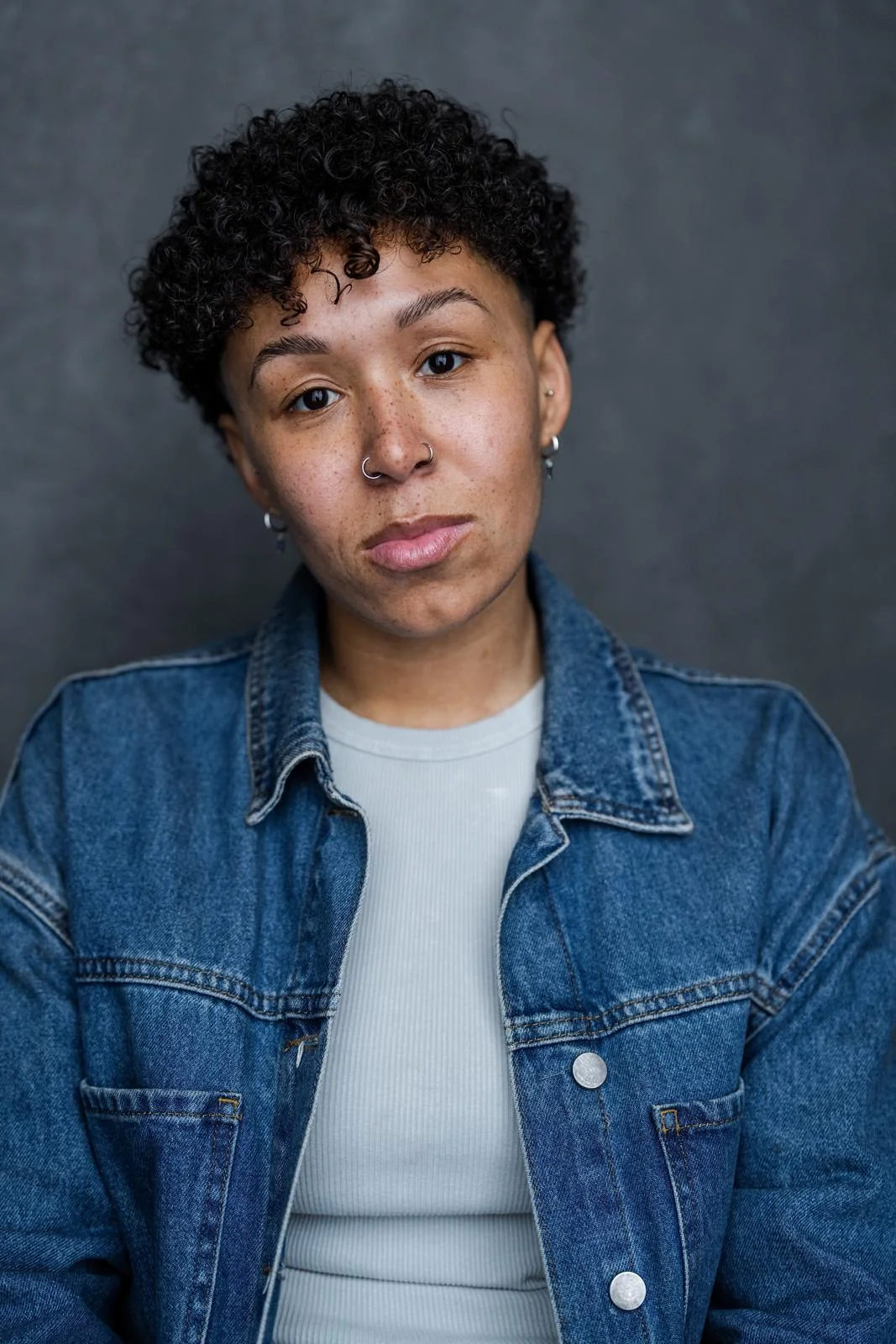 Professional portrait of Nicole Keri wearing a denim jacket